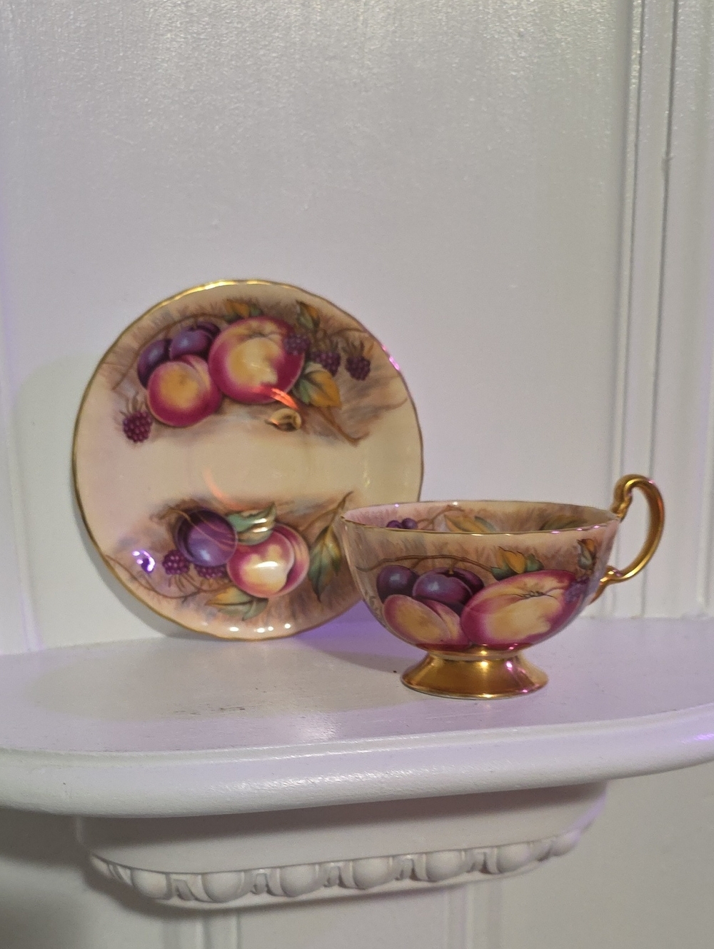 vintage Aynsley Orchard Gold tea cup and saucer set features hand-painted fruit